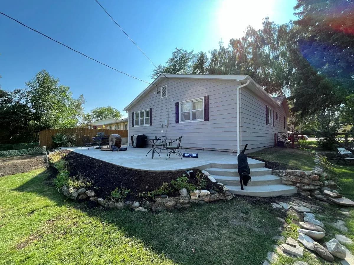 Wide view of a curved concrete patio remodel with integrated steps in Buffalo, Wyoming