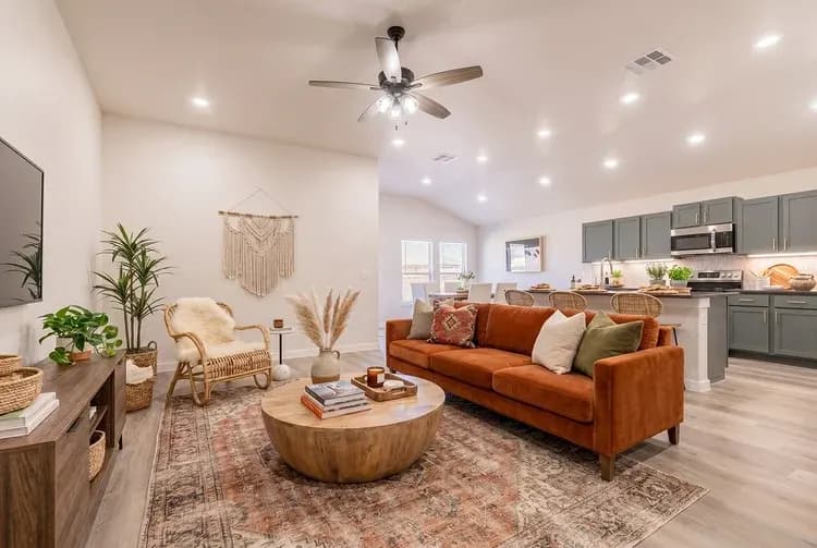 Living room with terracotta sofa in The Big Horn home model by Buffalo Built LLC.