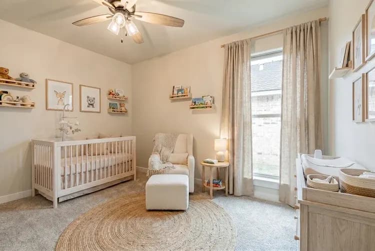 Bedroom staged as a nursery, alternate view, in The Bomber Mountain home model by Buffalo Built LLC.