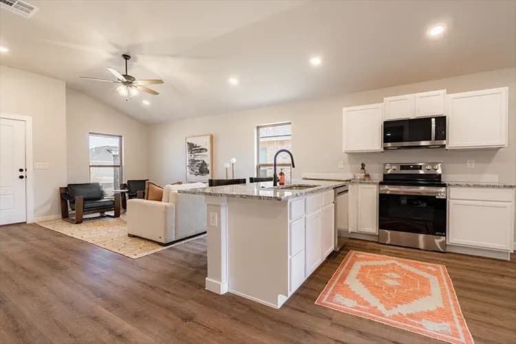 Kitchen and living area, alternate staging, in The Clear Creek home model by Buffalo Built LLC.