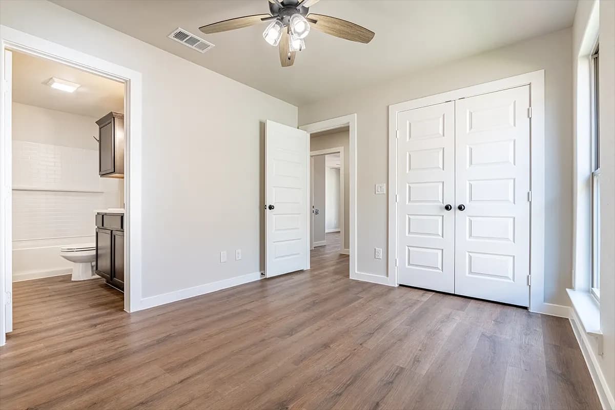 Unstaged bedroom with ensuite bath in The Cloud Peak home model by Buffalo Built LLC.
