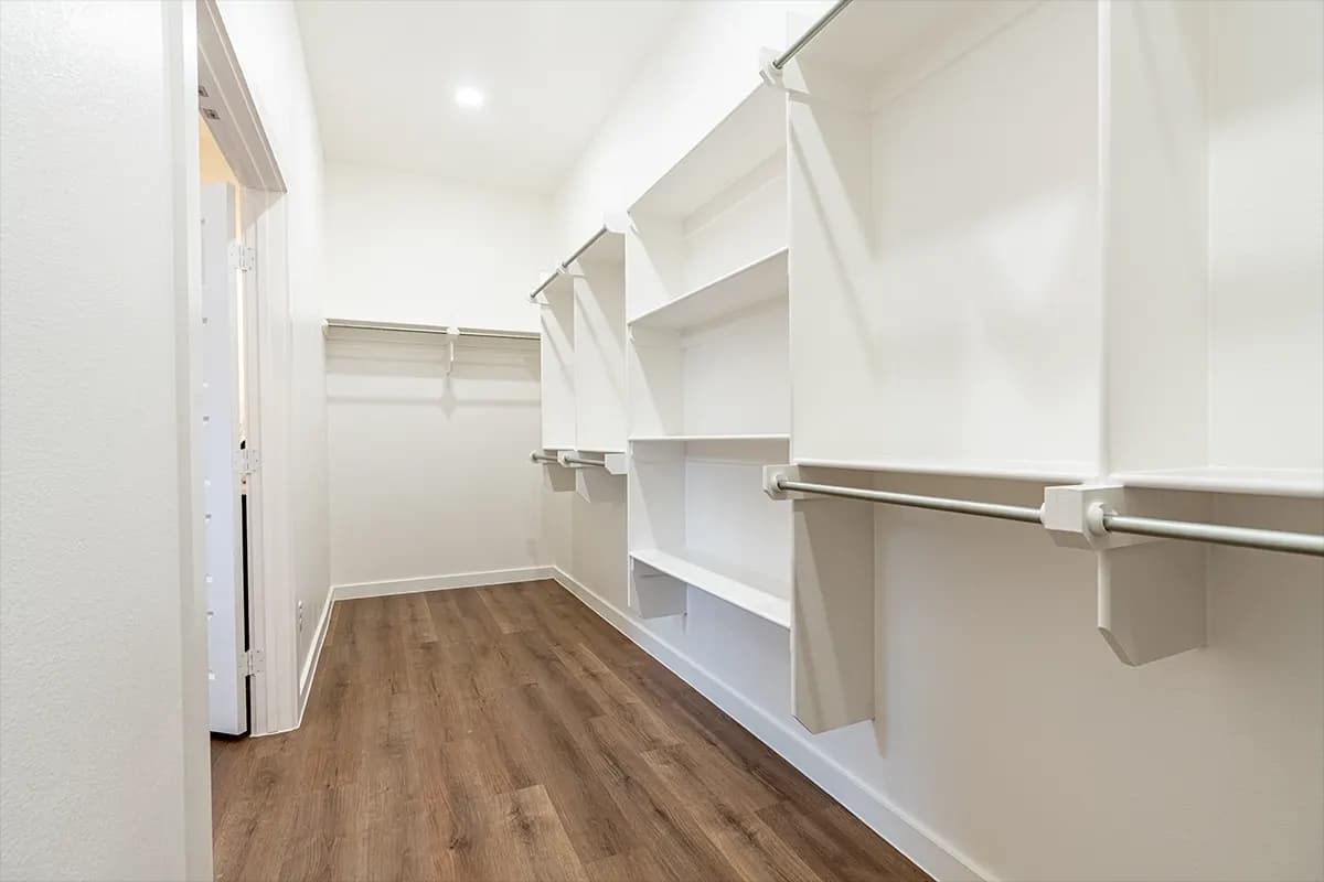 Unstaged primary walk-in closet in The Cloud Peak home model by Buffalo Built LLC.