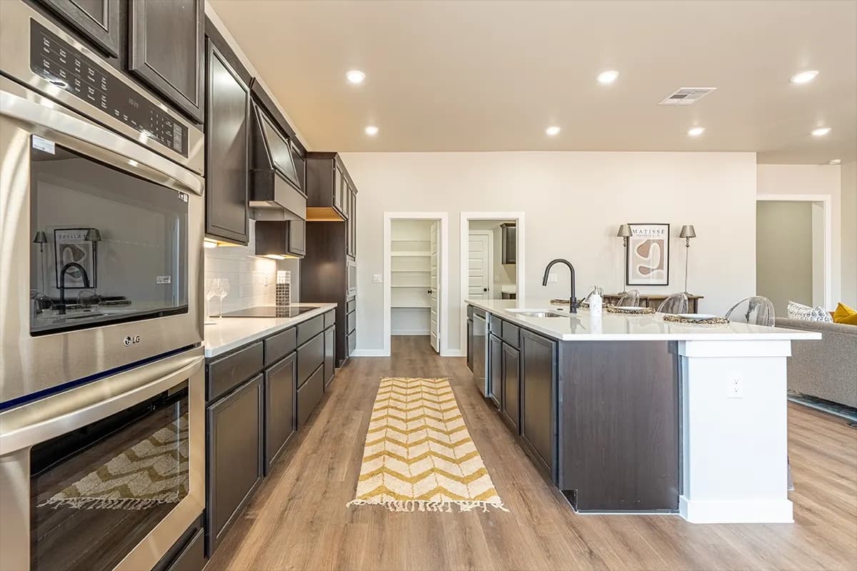 Kitchen with double wall ovens in The Cloud Peak home model by Buffalo Built LLC.