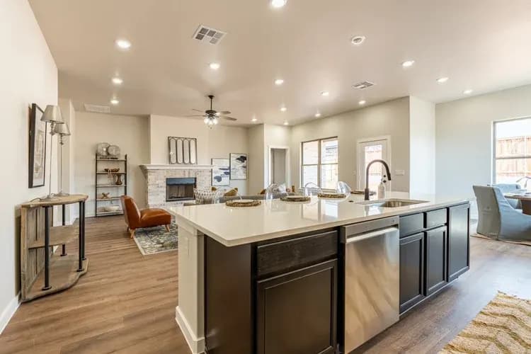 Kitchen island with living room beyond in The Cloud Peak home model by Buffalo Built LLC.