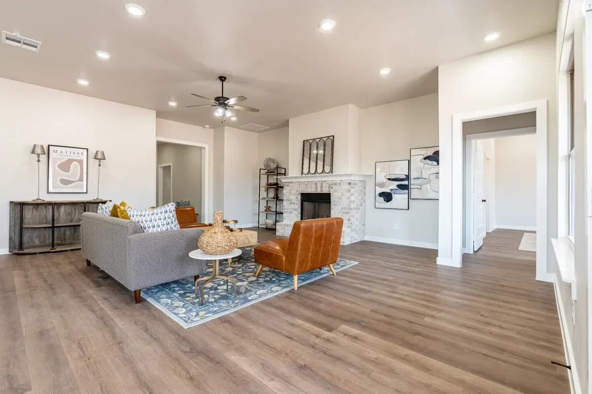 Living room with fireplace, wide view, in The Cloud Peak home model by Buffalo Built LLC.