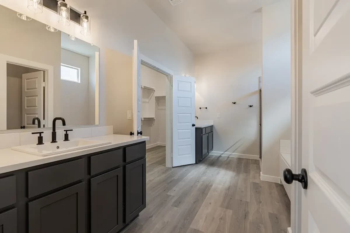 Primary bathroom with dual vanity in The Cloud Peak home model by Buffalo Built LLC.