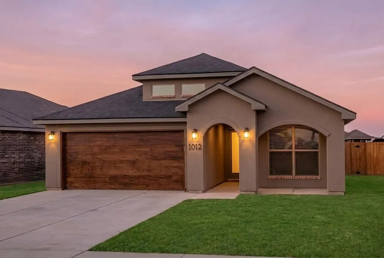 Exterior of The Crazy Woman home model at dusk by Buffalo Built LLC.