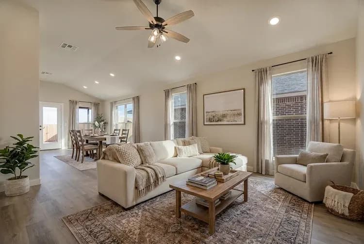 Living room with cream sectional in The Crazy Woman home model by Buffalo Built LLC.