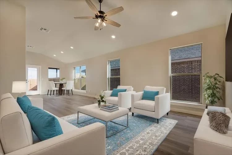 Living room with teal accents in The Crazy Woman home model by Buffalo Built LLC.