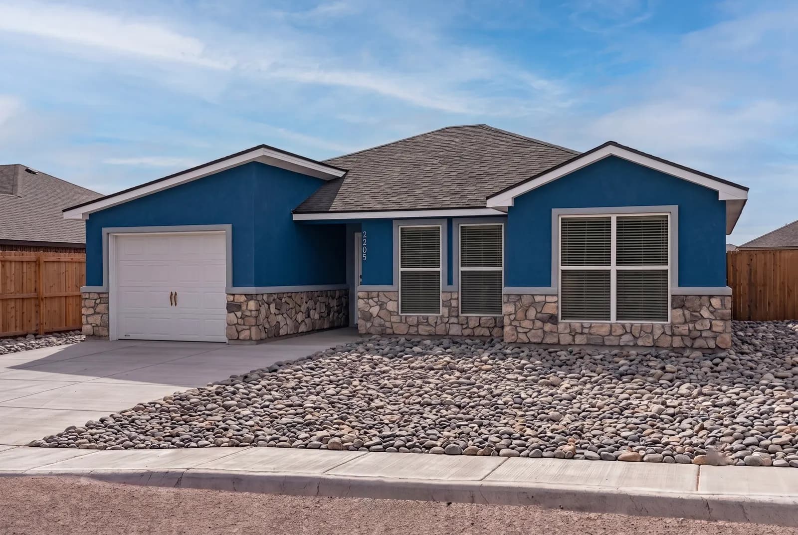 Exterior of The DeSmet home model at dusk by Buffalo Built LLC.