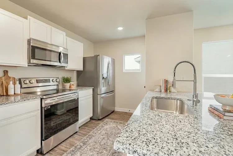 Kitchen with refrigerator and range in The French Creek home model by Buffalo Built LLC.