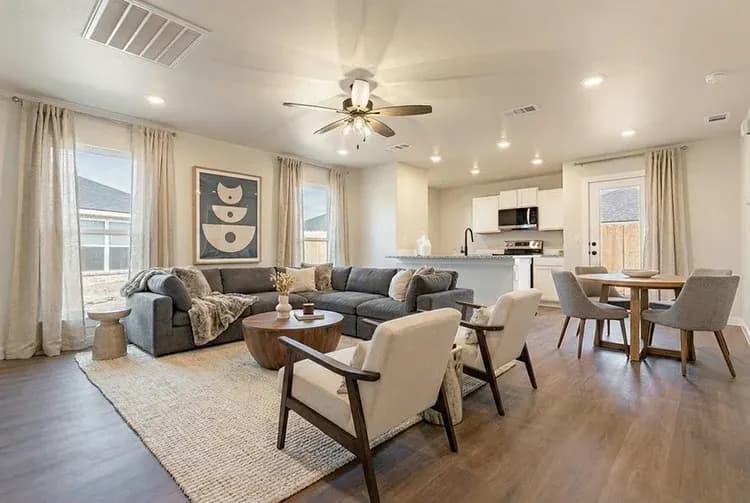 Living room with sectional sofa and dining table in The French Creek home model by Buffalo Built LLC.