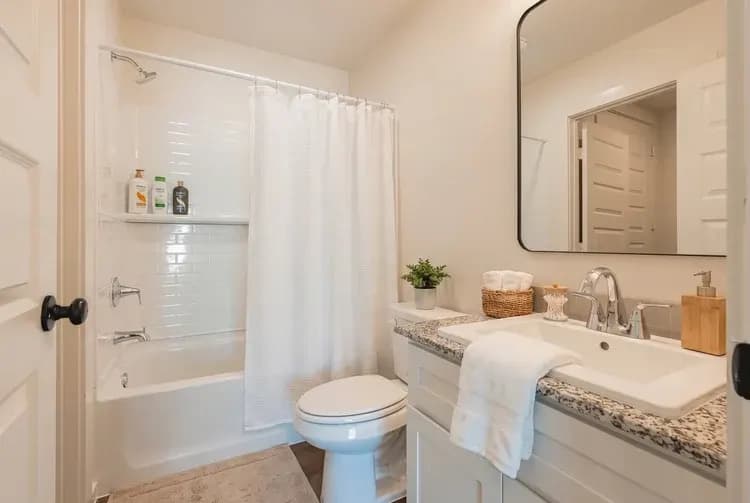 Bathroom with tub and vanity in The Little Big Horn home model by Buffalo Built LLC.