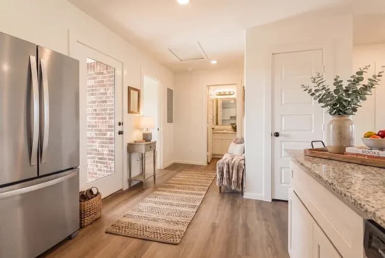 Kitchen and hallway to the side entry in The Little Big Horn home model by Buffalo Built LLC.
