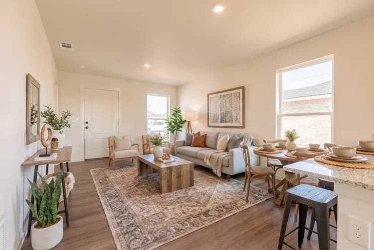 Living room and dining area, alternate view, in The Little Big Horn home model by Buffalo Built LLC.