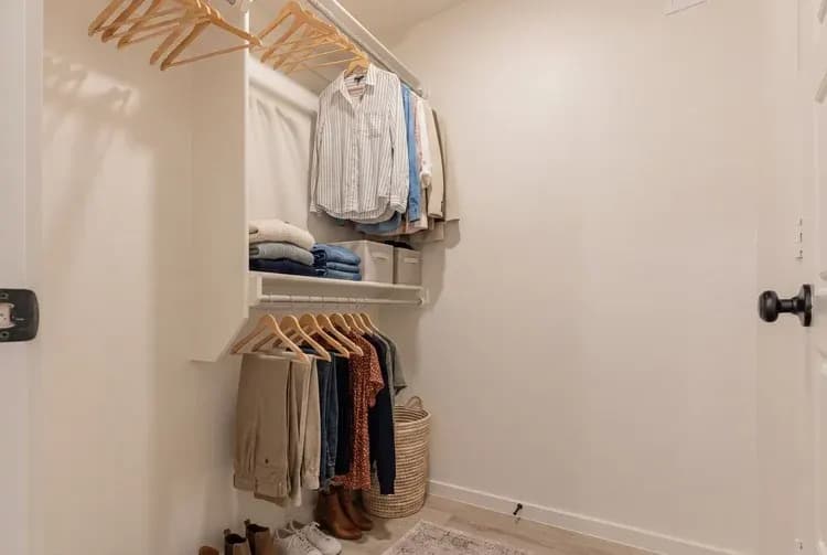 Primary bedroom walk-in closet in The Little Big Horn home model by Buffalo Built LLC.