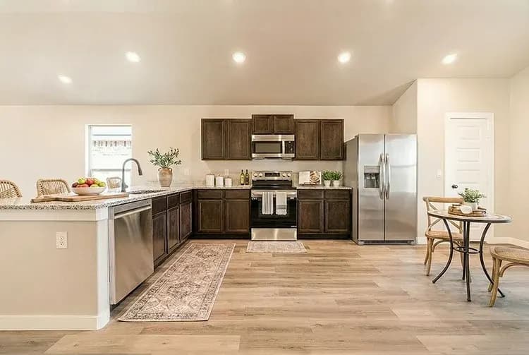 Kitchen and dining area in The Meadow Lark home model by Buffalo Built LLC.