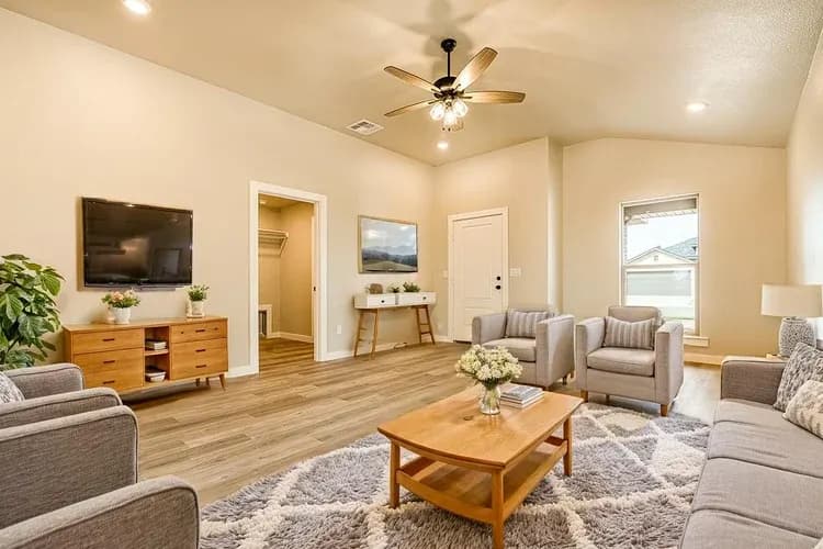 Living room with gray furniture in The Meadow Lark home model by Buffalo Built LLC.