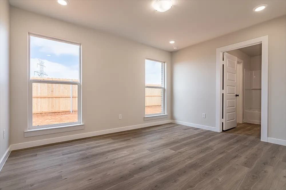 Unstaged bedroom in The Piney Creek home model by Buffalo Built LLC.