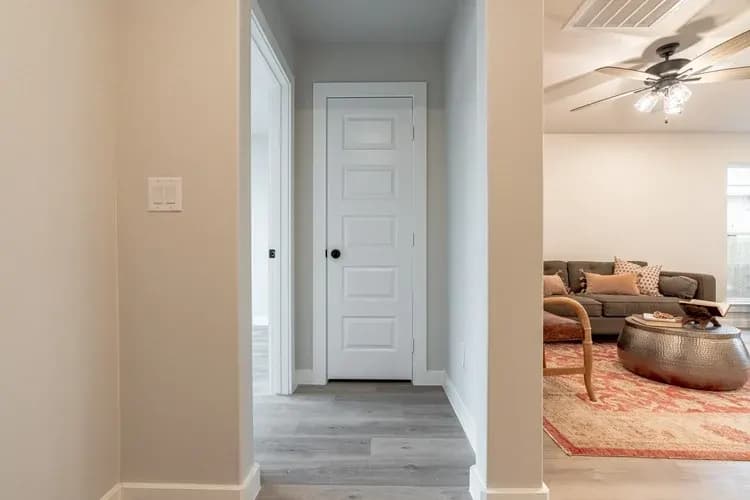 Hallway leading to the living room in The Piney Creek home model by Buffalo Built LLC.