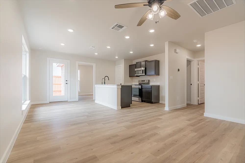 Unstaged kitchen with dark cabinetry in The Piney Creek home model by Buffalo Built LLC.