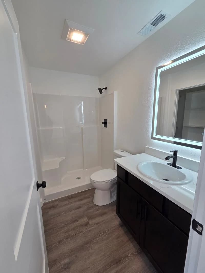 Bathroom with walk-in shower and vanity in the finished Tie Hack completed home