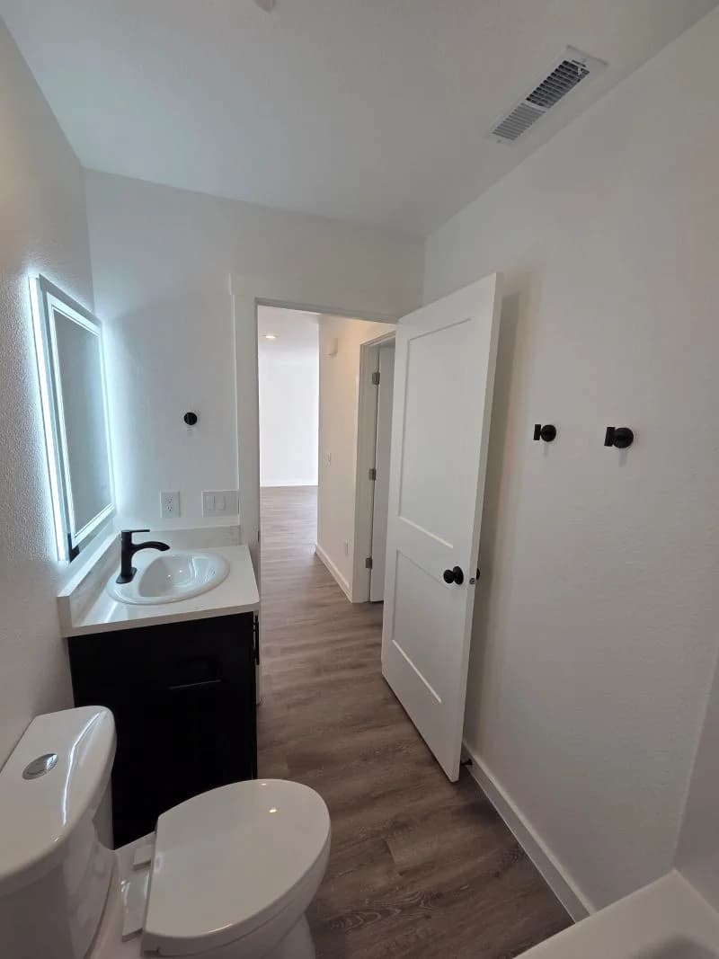 Bathroom 2 vanity with illuminated mirror in the finished Tie Hack completed home