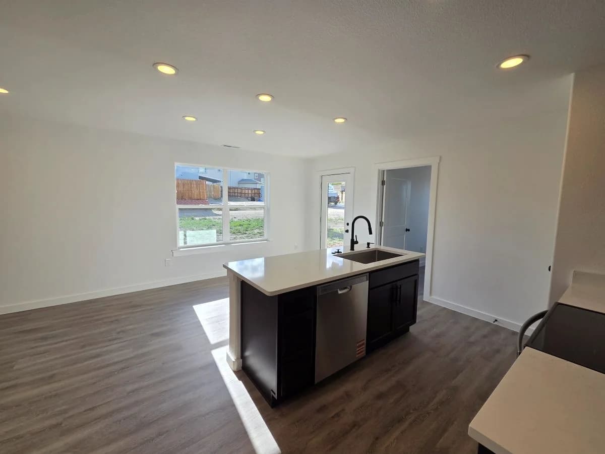 Kitchen island overlooking the open living area in the finished Tie Hack completed home