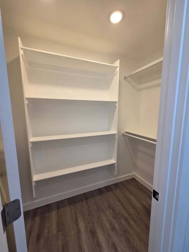 Primary bedroom closet with built-in shelving in the finished Tie Hack completed home