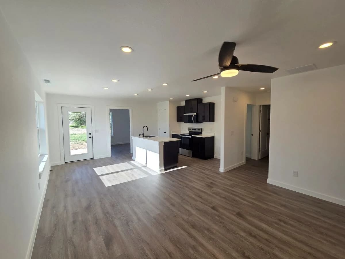 Open living and kitchen area inside the finished Tie Hack completed home