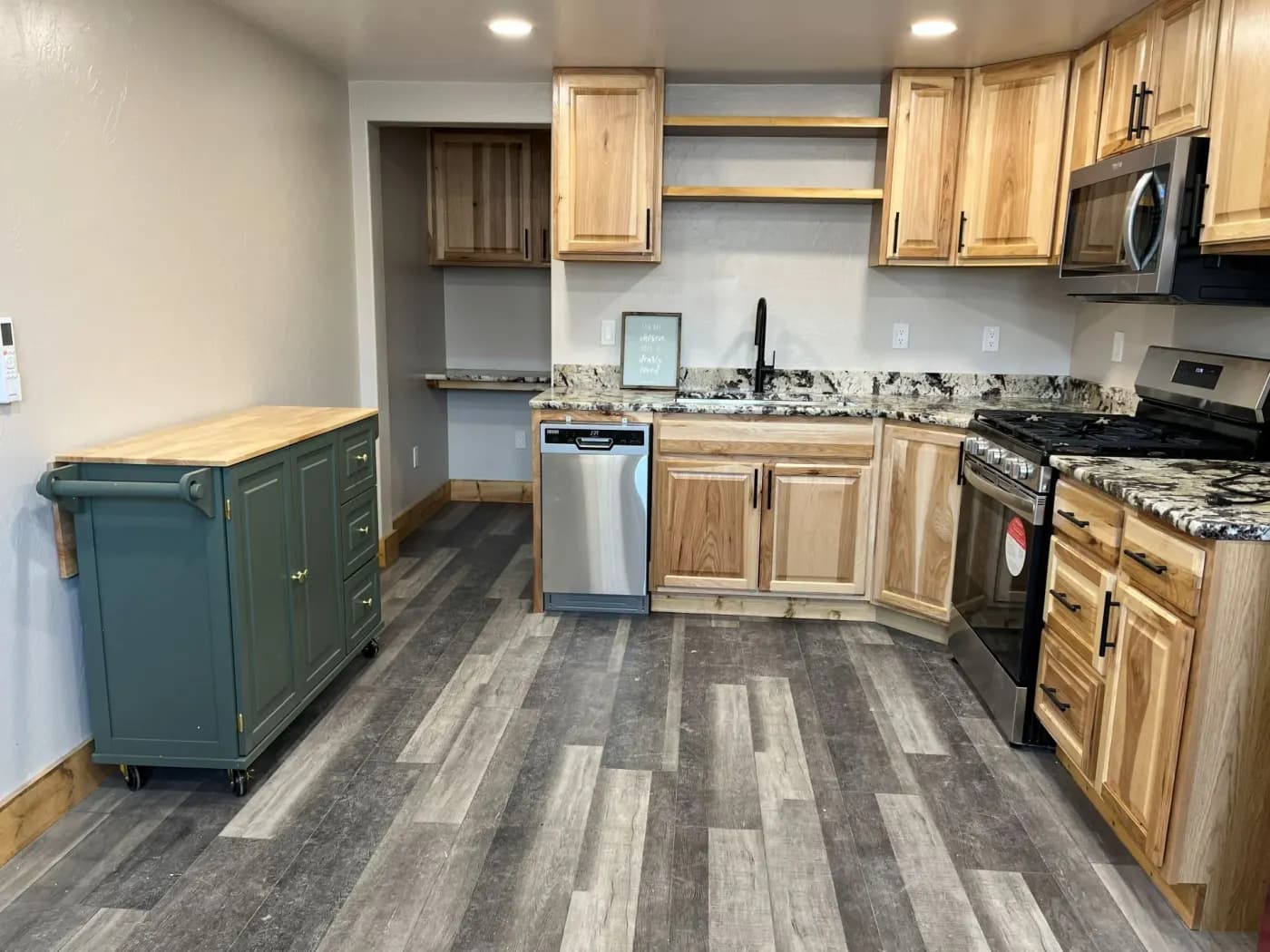 Residential kitchen remodel in Buffalo, Wyoming with wood cabinetry and new finishes.